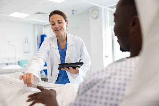Healthcare Professional with Tablet in Conversation