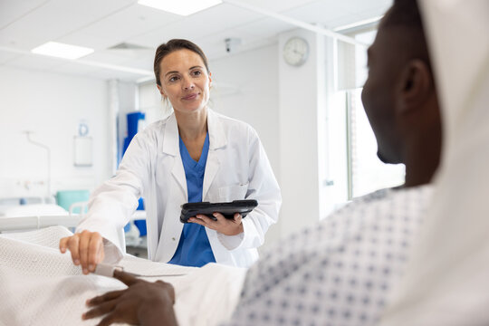 Healthcare Professional Attending to Patient in Bed