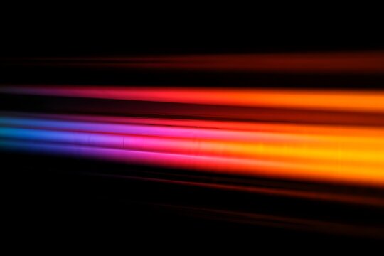 Abstract colorful light trails on a black background with dynamic movement