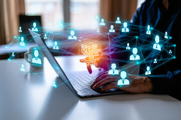 Photo of a persons hands typing on a laptop, with a glowing network of people icons and circuit board graphics overlaid