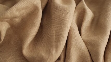 Closeup video of hands touching soft beige linen fabric. Appreciating pleasant texture of high quality textile for clothes. Soft and cozy textile. Expensive fabric for luxury clothes. - Powered by Adobe