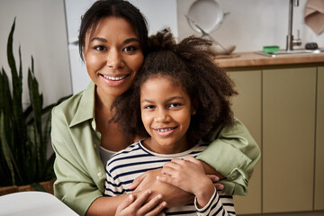 Mother and daughter share a joyful moment at home while creating lasting memories