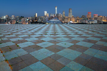 Square grid ground plaza and city skyline background