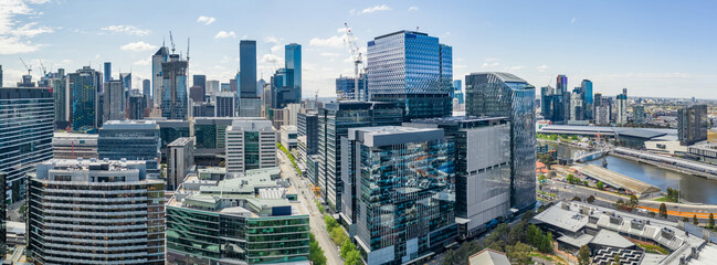 Aerial panorama of a modern city skyline along an inner city river at Docklands in Melbourne