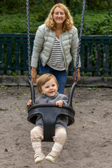 Stockholm, Sweden A grandmother pushes her one-year-old granddaughter in the swings.