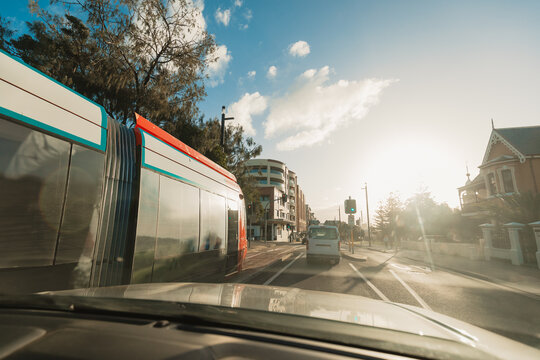 View from inside car of traffic on the road in golden afternoon light