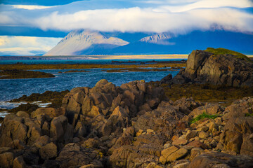 Rocky Coastline with Ocean and Mountains in Iceland