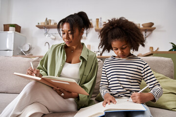 Mother and daughter enjoying creative time together at home in a cozy setting