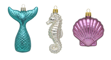 Obraz premium Set of three Christmas tree ornaments shaped like a mermaid tail, seahorse, and seashell in blue, white, and pink colors, perfect for ocean-themed holiday decor