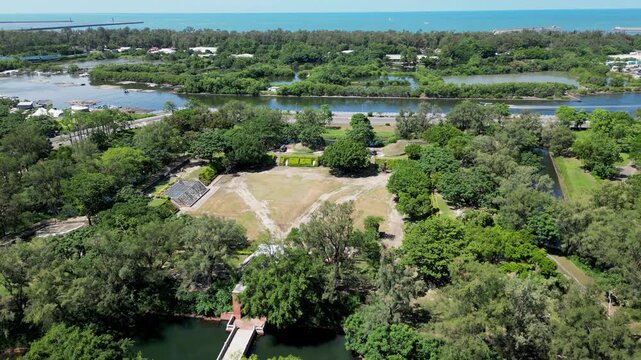 Aerial drone view of the historic Eternal Golden Castle (Erkunshun Fortress) and moat, with the Anping Harbor cityscape in summer. Tainan, Taiwan.