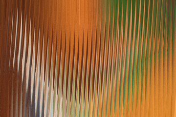 An abstract pattern of vertical lines in shades of orange, brown, and green, creating a textured, rippled effect