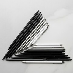 Elegant collection of monochromatic writing instruments on marble surface