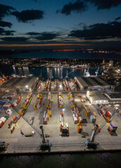 Aerial view to a container unloading terminal of port of Burgas, Bulgaria at night. Logistics and transport