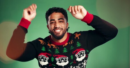 Dance, Christmas and smile with face of man in studio for celebration, holiday season and energy. Festive event, bokeh and happiness with person on green background for xmas vacation and December - Powered by Adobe