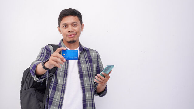 Asian Man Smiling with Backpack Holding Smartphone and Credit Card