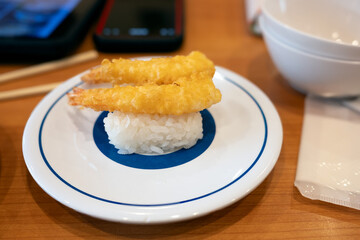 Ebi fry nigiri sushi or fried shrimp sushi on a saucer 