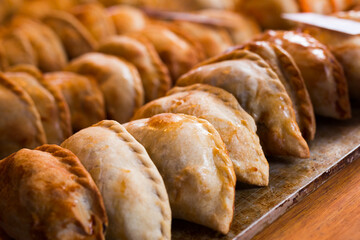 freshly baked empanadas with different fillings for sale