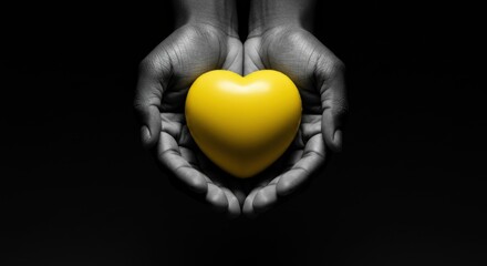 Black and white hands holding a yellow heart against a black background. Love and care concept.