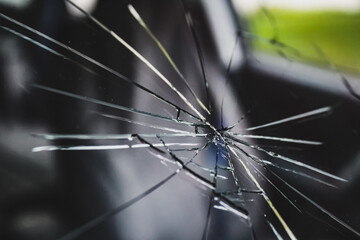 a shattered piece of glass on a car windshield or window with radial cracks. transportation and automotive repair design element. starburst pattern. concept of stress or fractured. art design element.