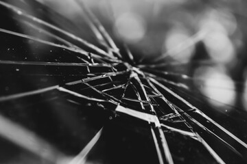 close-up of fractured glass on a windshield with bokeh light effect. abstract texture background....