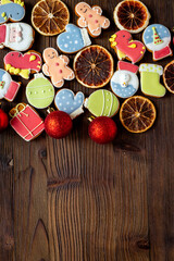 Set of different Christmas and New Year gingerbread cookies on dark wooden background, top view. Festive food concept