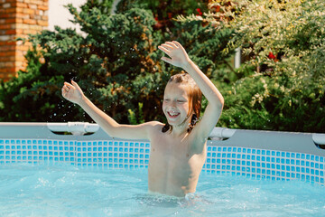 A young boy splashes joyfully in a swimming pool on a sunny day. He interacts playfully with his father and brother, creating cherished memories by the water.