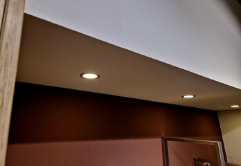 The niche is painted on the wall. There are spotlights on the ceiling in the plasterboard. Living room or kitchen