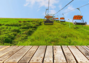 Wooden table top on blur mountain and grass field.Fresh and Relax concept.For montage product display or design key visual layout.View of copy space.