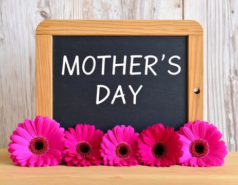 Mother's Day message on a chalkboard with flowers - Powered by Adobe