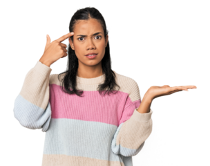 Young Filipina woman holding and showing a product on hand.