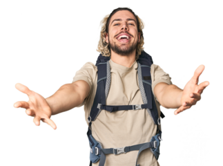 Young Caucasian hiker with backpack showing a welcome expression.
