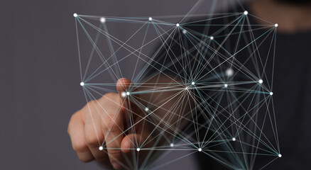 Abstract image of a hand interacting with a digital network.  Represents connection, technology, and global communication.