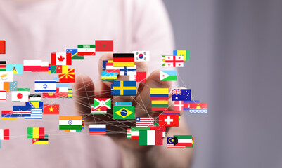 Image of a hand interacting with a network of flags representing global connections and international relations.