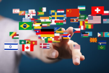 Person's finger interacts with numerous flags, representing international connections and global...