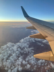 The wing of a passenger aircraft and sky