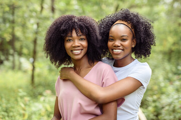 Fototapeta premium Black American mother and her daughter in forest.