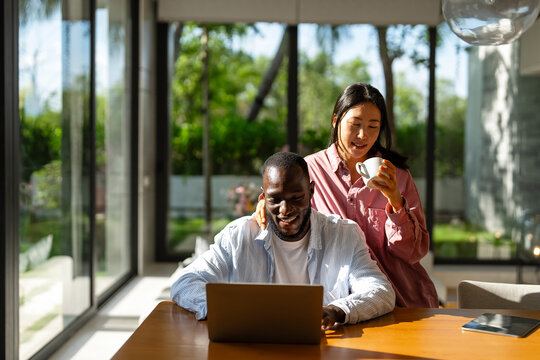 Online entertainment and social media. Diverse, multiethnic couple enjoying the digital world