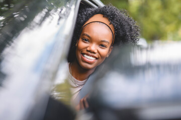 Young black teenage driver in her new car