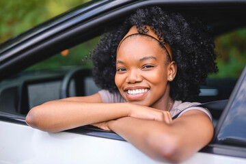 Young black teenage driver in her new car