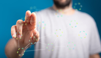 A man's hand interacts with a digital network, showcasing connectivity and technology.