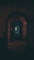 Fototapeta premium A vertical shot of a corridor in an old building with a dark shadow