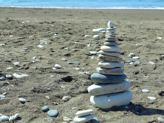 a pyramid of stones on the seashore