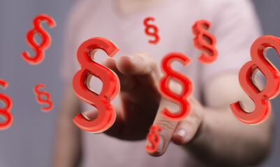 Abstract image of a hand and red paragraph symbols.  Legal, law, justice concept.