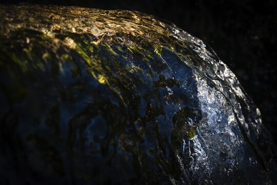 Water of a stream flowing over rocks, water jet, light reflections, Otroya or Otr&oslash;ya Island, M&oslash;re og Romsdal, Norway