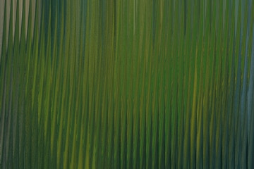 Abstract vertical lines of green and yellow create a textured, organic pattern reminiscent of tall grass or reeds swaying in the wind