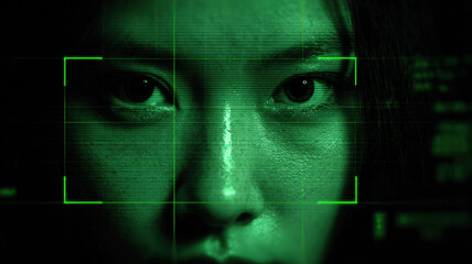 Facial recognition technology interface with green scanning frames on human face creating futuristic biometric concept
