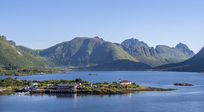 Place and small church Sildpollnes Kirke at the fjord Austnesfjorden, idyllic Norwegian fjord landscape, Sildpollen, Nordland, Norway