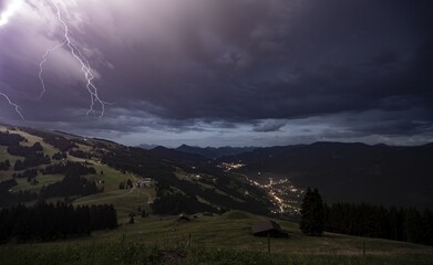 Dark storm clouds, thunderstorm with lightning in the mountains, view over the Brixen valley at night, Hochbrixen, Brixen im Thale, Kitzbühel Alps, Tyrol, Austria