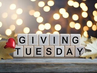 Giving tuesday spelled out with letter tiles and festive bokeh lights