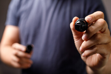 Close-up of a man's hand holding a black marker, ready to write or draw. Perfect for concepts of creativity, ideas, and presentation.